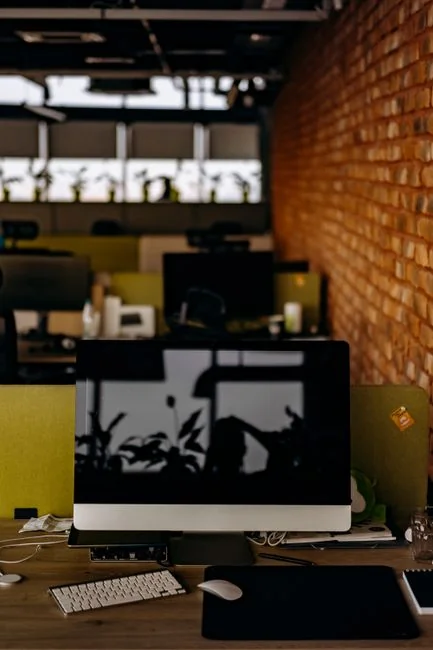 Group of designers collaborating in modern office space with computer.